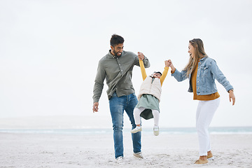 Image showing Swinging, holding hands and a family at the beach for walking, bonding or playing together. Happy, playful and a mother, father and boy kid at the ocean for a holiday, relax and love during travel