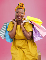 Image showing Shopping bag, studio portrait and happy black woman excited for discount promotion, boutique sales or commerce deal. Happiness, package gift or African customer with retail present on pink background