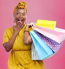 Image showing Shopping bag, studio and black woman surprise over discount notification, sales announcement or commerce deal. Wow, package gift and African customer shocked with retail news offer on pink background