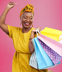 Image showing Shopping, smile and black woman with bags, excited and retail on a pink studio background. African person, customer and model with luxury items, expensive clothes and boutique products with wealth