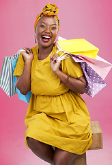 Image showing Shopping bag, studio portrait and black woman excited for discount promotion, fashion spree choice or commerce deal. Market product, package or African customer with retail present on pink background