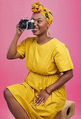 Image showing Camera, studio and happy black woman shooting photo, picture or photography of creative fashion design. Creativity photoshoot, talent artist and African production photographer on pink background