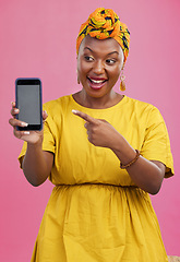 Image showing Happy black woman, phone and pointing to mockup space in advertising against a studio pink background. African female person smile showing technology app, display or screen for deal, discount or sale