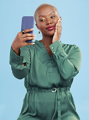Image showing Smile, selfie and happy black woman for mobile app video call isolated in studio blue background with prize. Connection, calm and person, content creator or influencer live streaming on social media
