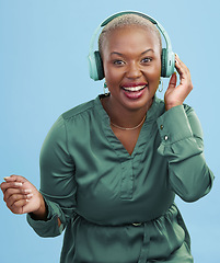 Image showing Dance music, portrait or happy black woman have fun, smile and listening to podcast, radio network or song. Happiness, studio or African dancer streaming audio, headphones or sound on blue background