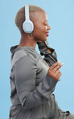 Image showing Black woman, headphones and music, profile and technology with audio streaming isolated on blue background. Listening to radio, wireless tech for podcast and subscription with peace in studio