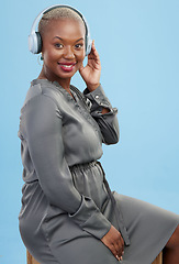 Image showing Black woman, headphones and music in studio portrait, smile and listening to radio by blue background. African girl, audio tech and streaming subscription service with sound, hearing and relax