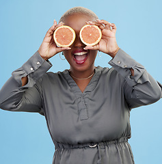 Image showing Happy black woman, orange and vitamin C in diet, natural nutrition or detox against a studio background. Portrait of African female person smile with healthy organic citrus fruit for body wellness