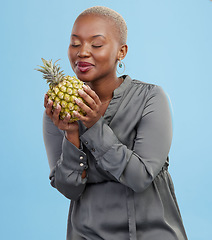 Image showing Pineapple, diet and black woman in studio with advice, lose weight or digestion and gut health tips on blue background. Fruit, detox or African nutritionist with organic, raw and superfoods guide