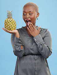 Image showing Pineapple, wow and surprise with a health black woman in studio on blue background for diet or nutrition. Wellness, fruit or food with a young person looking shocked by vitamins or minerals benefits