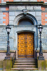 Image showing Old door with lamp poles