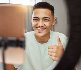 Image showing Phone, thumbs up and happy man in living room with social media, review or thank you. Ring light, smile and guy influencer online with feedback hand emoji, support or live streaming, blog or podcast