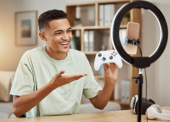Image showing Man, live streaming for gaming and social media influencer, .smartphone filming tech review, online gamer with controller. Video game promo, streamer with ring light for content creation and feedback