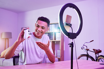 Image showing Streamer, live streaming and man gamer with review of console controller on social media for connection on vlog. Ring light, influencer and content creator or person speaking on internet show as host