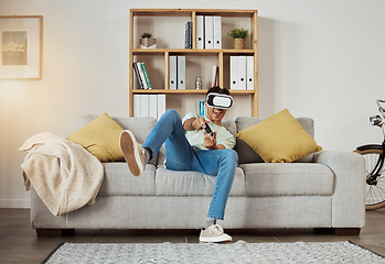 Image showing Virtual reality glasses, excited and man with game, futuristic and metaverse with connection, smile and relax. Person, gamer or guy on a couch, VR eyewear and home with online playing and controller