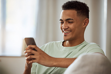Image showing Home, smile and man with a cellphone, relax and typing with connection, digital app or social media. Person on a couch, lounge or guy with a smartphone, meme and website info with internet or network