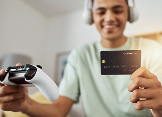 Image showing Headphones, credit card and man on esports video game ecommerce for purchase with controller in virtual challenge. Internet, user experience and person or esport gamer streaming sports games online