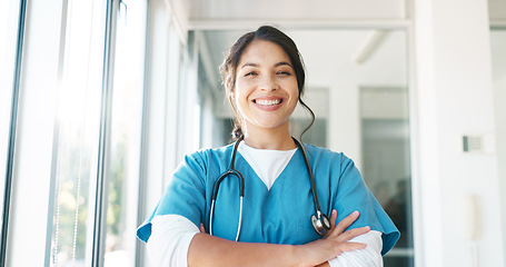 Image showing Doctor in portrait, woman with arms crossed and healthcare, smile with confidence at hospital with pride and help. Medical professional, trust and consultation at clinic with scrubs and medicine