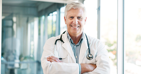 Image showing Doctor in portrait, senior man with arms crossed and healthcare, smile with confidence at hospital with pride and help. Medical professional, trust and expert at clinic with service and medicine