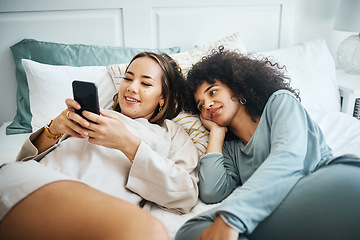 Image showing Phone, love and a lesbian couple in bed together in the morning for communication or to relax. Social media, lgbt and a woman watching a movie or video with her girlfriend in the home bedroom