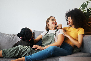 Image showing Dog, relax or happy lesbian couple on sofa together in healthy relationship or lgbtq love connection. Talking, conversation or gay women smile with pet, bond or care in house living room on couch