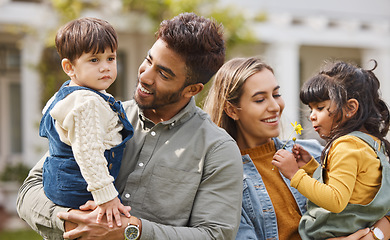 Image showing Mother, father and happy outdoor with children and a flower in spring with love, care and security. A man, woman and kids or young family in a backyard to relax while bonding on holiday or vacation