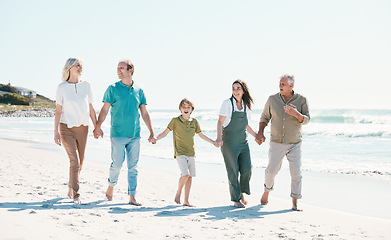 Image showing Walking, beach and family holding hands together on vacation, holiday or tropical weekend trip. Happy, travel and child with parents and grandparents bonding by ocean or sea on adventure in Australia