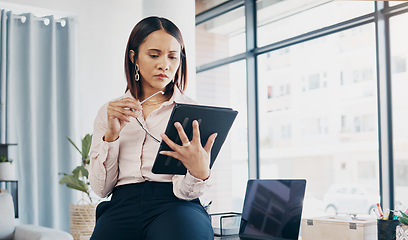 Image showing Businesswoman in office, reading and thinking with tablet for email, HR schedule or report online for feedback. Research, networking and communication on digital app, woman at human resources agency.