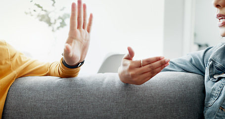 Image showing Argument, hands and closeup of couple on a sofa in the living room for cheating, fight or toxic relationship. Conversation, discussion and zoom of man and woman talking for communication at home.