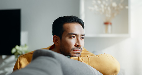 Image showing Thinking, memory and sad asian man on a sofa with nostalgia, depression or grief in his home. Burnout, worry and Japanese male in living room with broken heart, mourning or anxiety for loss and debt