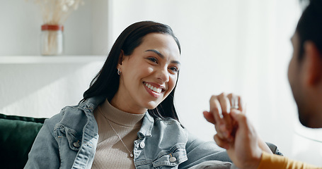 Image showing Couple, kiss on hand and talking on home sofa with smile, security and love in healthy relationship. Young man and woman together in living room for affection, funny laugh and communication with care