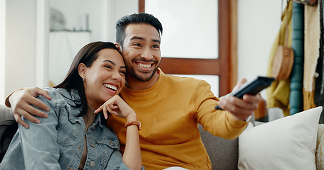 Image showing Happy couple, relax and watch movies on tv, news and cable show for media broadcast on sofa at home. Man, woman and people change television remote for streaming multimedia, subscription and choice