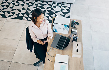 Image showing Smartphone, laptop and business woman at table in home living room on social media, research and freelancer typing. Happy designer on phone at desk, reading email and communication for remote work