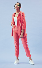 Image showing Fashion, portrait and girl in suit in studio with makeup, confidence and body in outfit. Beauty, style and influencer woman in designer clothes, trendy promo and model standing on blue background.