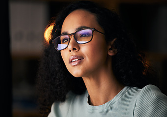 Image showing Business woman, glasses and reading on computer for programming, software or information technology solution. Young night programmer in screen reflection for IT problem solving, results or web coding