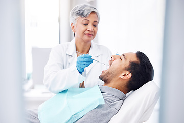 Image showing Woman, dentist and check teeth of man with tools for dental cosmetics, healthcare assessment and medical consulting. Patient, tooth and oral cleaning with mirror, excavator and orthodontic surgery