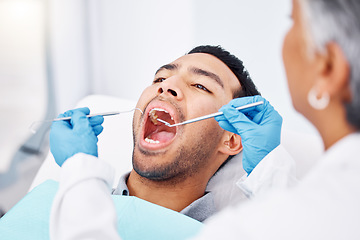 Image showing Dentist, patient man and consultation for mouth and teeth whitening, cleaning or veneers hygiene. Oral health, orthodontics and a person for tooth care, dental assessment and mirror tools at clinic