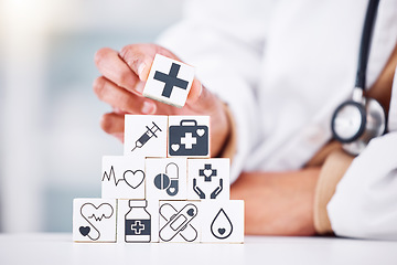 Image showing Hands, medical and a building blocks in a hospital with a doctor closeup for health insurance. Healthcare, icon and symbol with a medicine professional and tower in clinic for cardiology or treatment