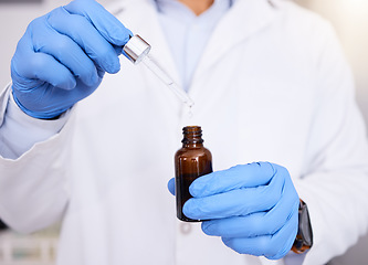 Image showing Scientist, hands and pipette with oil for experiment, dosage or measurement in laboratory. Closeup of medical person or healthcare professional with gloves, serum or vial in research test at lab