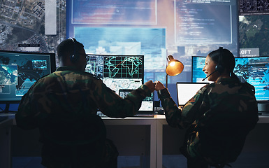 Image showing Control room, military and fist bump by soldier team on surveillance together at night for communication. Technology, global and teamwork by security with success on satellite map in army office