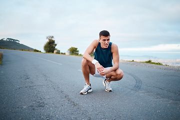 Image showing Sports, nature and man athlete breathing on break of race, marathon or competition training and workout. Fitness, fatigue and tired young male runner resting for outdoor cardio exercise for endurance