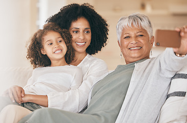 Image showing Family, selfie and living room couch with a smile, grandmother and child together with mom. Bonding, sofa and happy mother with a young girl and senior woman with photo for social media post at home