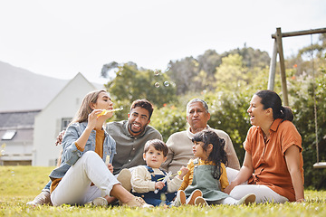 Image showing Big family, grandparents and children for picnic, relax and bubbles on grass or garden outdoor in summer. Love, people and kids in backyard of home for care, freedom and bonding in nature or park