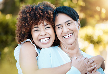 Image showing Happy, portrait and woman hugging her senior mother in nature at an outdoor park in summer. Smile, love and young female person from Mexico embracing her elderly mom with care in a field for bonding.