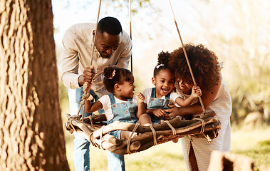 Image showing Parents with kids in park, tree swing and freedom for love, bonding or peace in nature together. Mother, father and children adventure in garden, black family on summer weekend in woods or forrest.