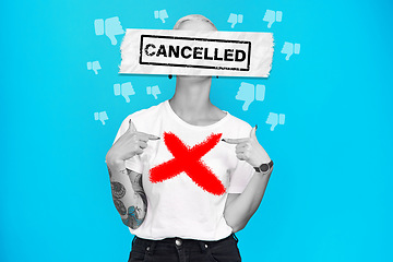 Image showing Cancel culture, woman and text overlay with graphic and bad emoji for social media ban in studio. Blue background, cross and dislike banner with online public shame with accountability and protest