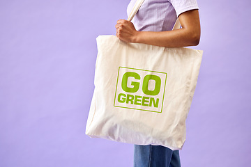 Image showing Sustainable, shopping and eco friendly bag by person or recycling customer isolated in a studio purple background. Environment, retail and woman with carbon footprint, zero waste and grocery