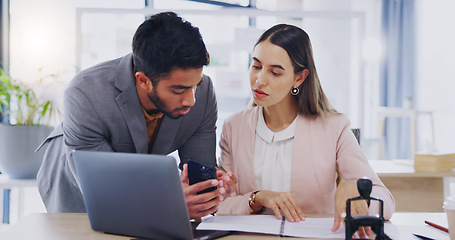 Image showing Laptop, phone and review with business people in the office, working together in discussion of a text message. Collaboration, communication or feedback with a man and woman employee talking at work