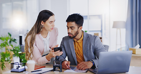 Image showing Laptop, phone and review with business people in the office, working together in discussion of a text message. Collaboration, communication or feedback with a man and woman employee talking at work