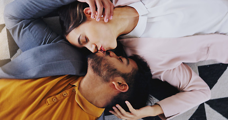 Image showing Embrace, above and couple kiss on the floor for love, care and comfort in relationship. Happy, affection and a man and woman kissing for happiness, marriage and romance together with a smile